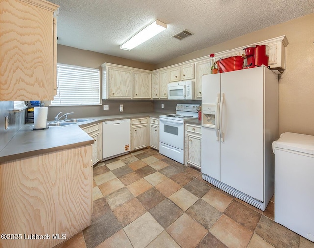 401 Oshkosh Ave, Lubbock, TX 79416 - kitchen with white appliances, stone finish floors, and a textured ceiling