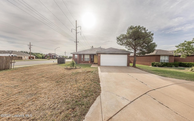 401 Oshkosh Ave, Lubbock, TX 79416 - ranch-style house with brick siding, concrete driveway, a front lawn, and a garage