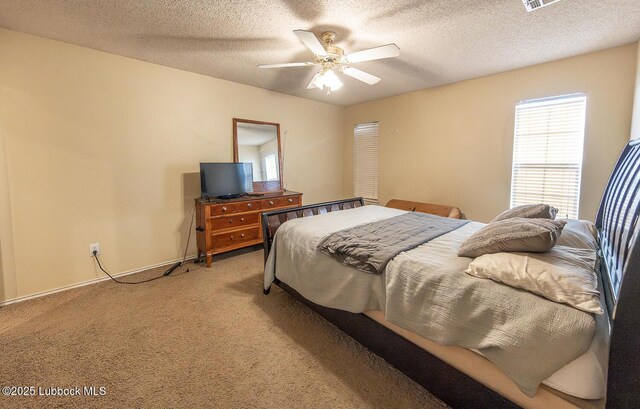 401 Oshkosh Ave, Lubbock, TX 79416 - bedroom featuring light carpet, a ceiling fan, and a textured ceiling