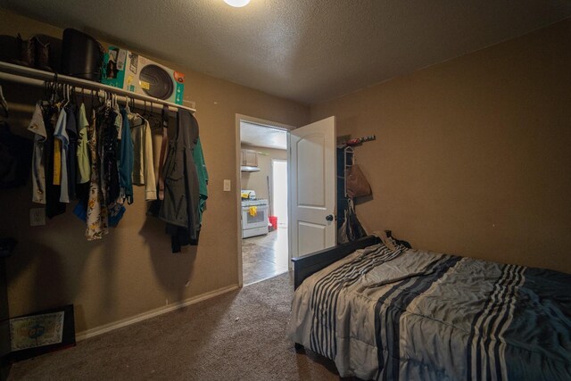 bedroom with carpet floors, a textured ceiling, and a closet