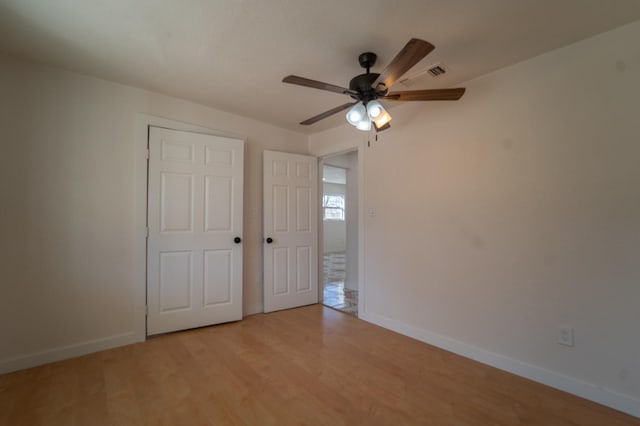 unfurnished bedroom with ceiling fan and light hardwood / wood-style floors