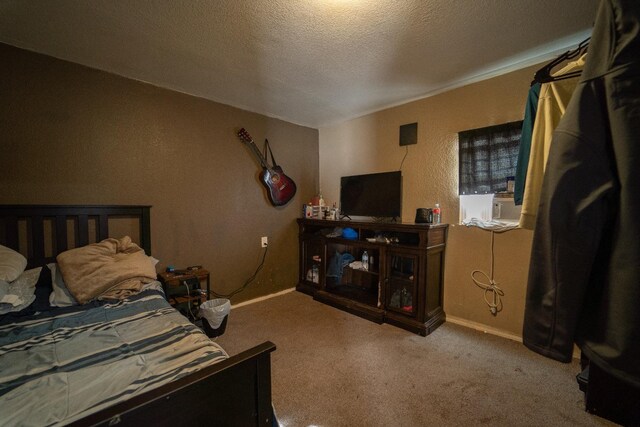 carpeted bedroom featuring a textured ceiling