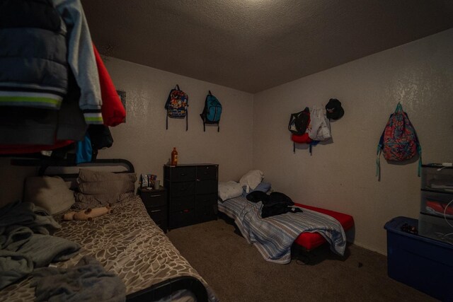 carpeted bedroom featuring a textured ceiling