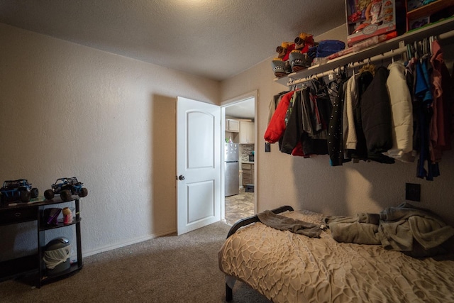 carpeted bedroom featuring stainless steel fridge