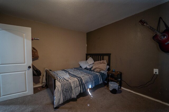 carpeted bedroom with a textured ceiling