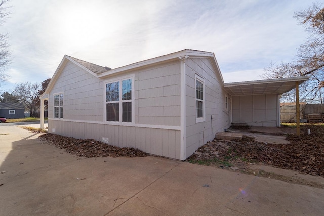 view of side of home with a carport