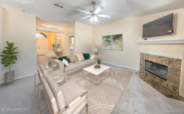 living area featuring baseboards, visible vents, and ceiling fan