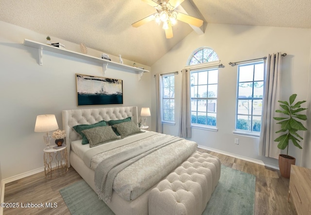 bedroom featuring vaulted ceiling with beams, baseboards, wood finished floors, and a textured ceiling