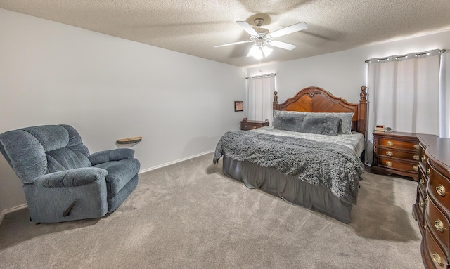 bedroom featuring baseboards, a textured ceiling, carpet, and ceiling fan