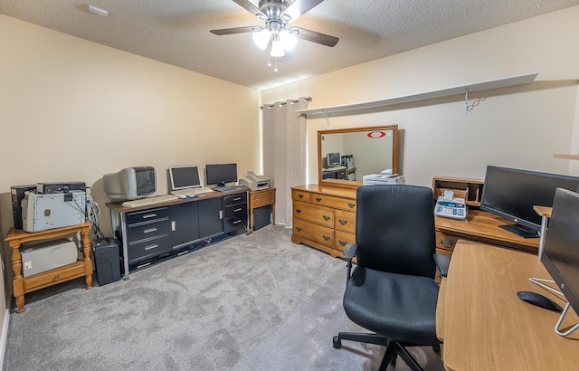 office space featuring ceiling fan, carpet flooring, and a textured ceiling