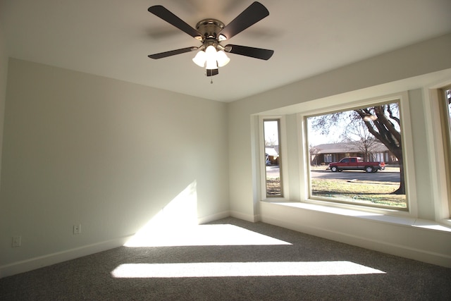 carpeted spare room featuring baseboards