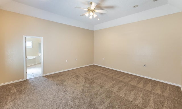 carpeted spare room featuring ceiling fan