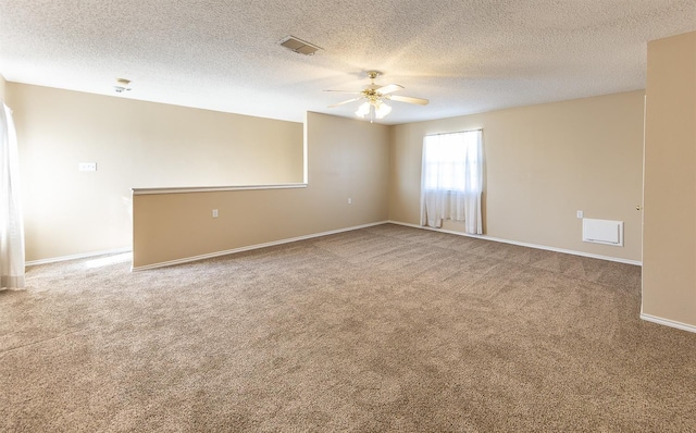 carpeted spare room featuring a textured ceiling and ceiling fan