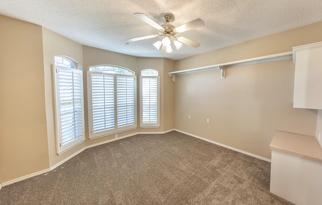 unfurnished room featuring carpet, a textured ceiling, and ceiling fan