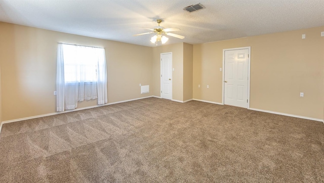 unfurnished room featuring ceiling fan, carpet flooring, and a textured ceiling