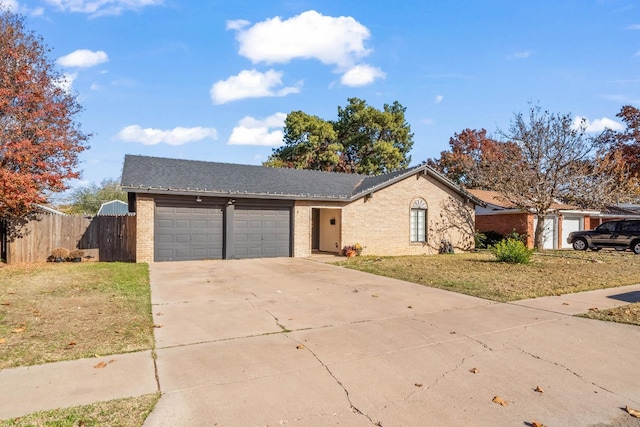 ranch-style house featuring a garage and a front yard