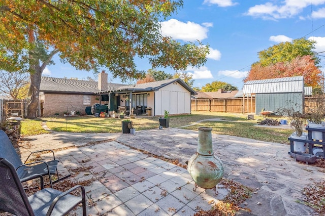 view of patio featuring a storage shed