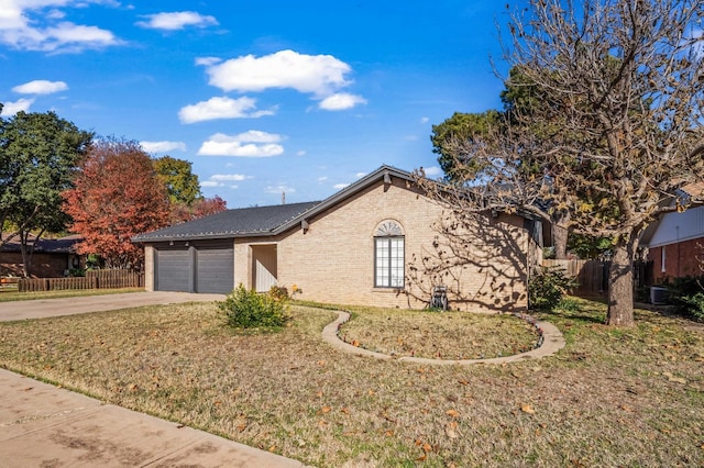 single story home with a garage, central AC, and a front yard