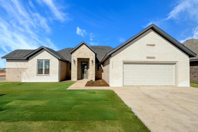 view of front of property with stone siding, a front yard, concrete driveway, and an attached garage