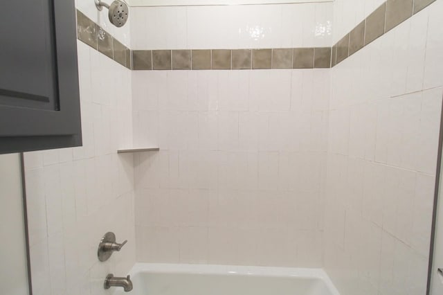 room details featuring shower / bathtub combination