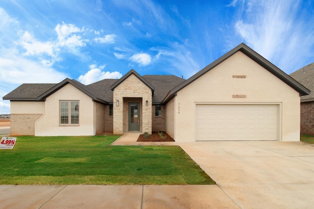 view of front of home with a garage and a front lawn