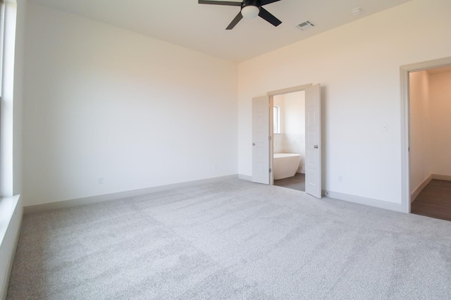 unfurnished bedroom with visible vents, a ceiling fan, carpet flooring, connected bathroom, and baseboards