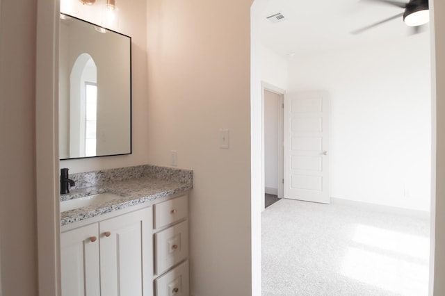 bathroom with vanity, visible vents, and a ceiling fan