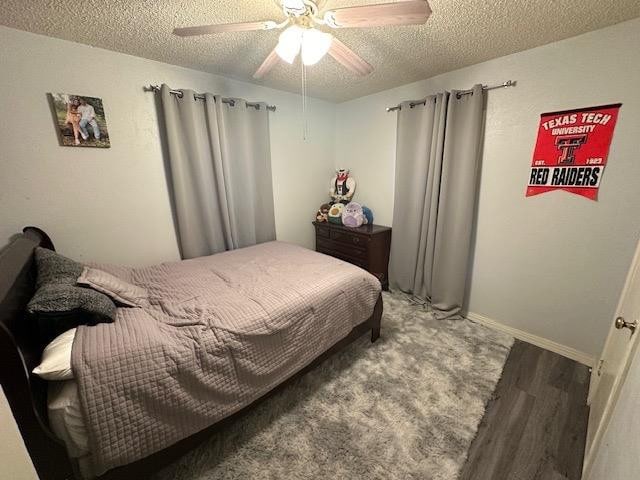 bedroom with hardwood / wood-style floors, a textured ceiling, and ceiling fan