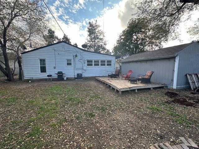 rear view of house featuring a deck