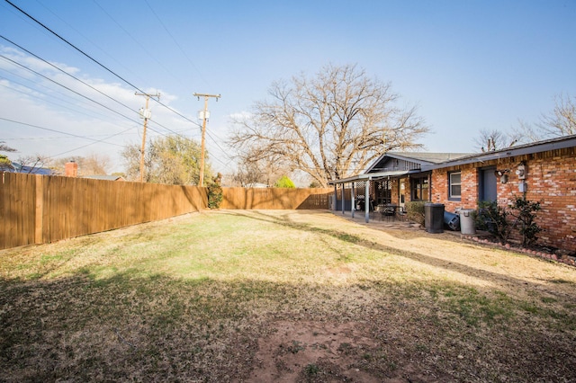 view of yard with a fenced backyard and a patio area