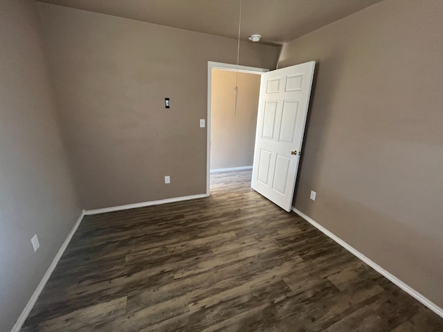 empty room featuring dark hardwood / wood-style flooring