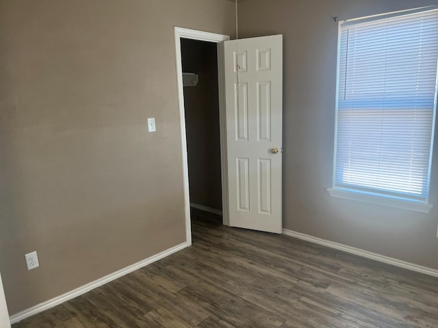 unfurnished room featuring dark wood-type flooring