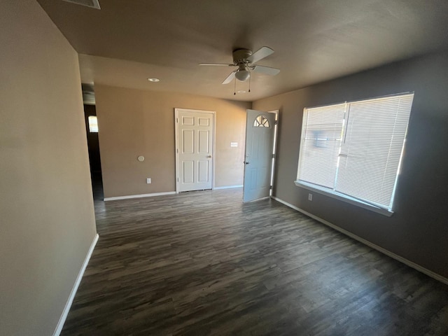 spare room featuring ceiling fan and dark hardwood / wood-style flooring