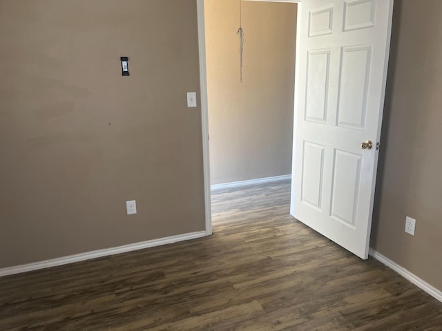 empty room with dark wood-type flooring