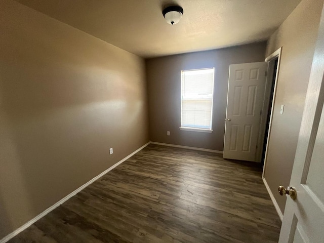 spare room featuring dark hardwood / wood-style flooring