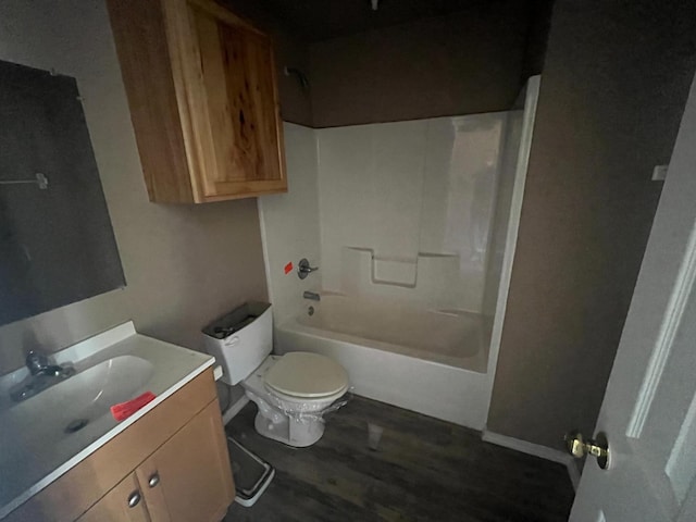 full bathroom with hardwood / wood-style flooring, shower / tub combination, vanity, and toilet