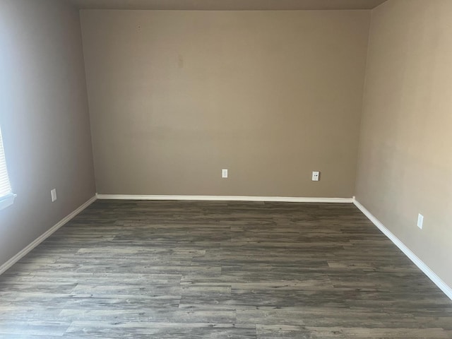 spare room featuring dark hardwood / wood-style flooring