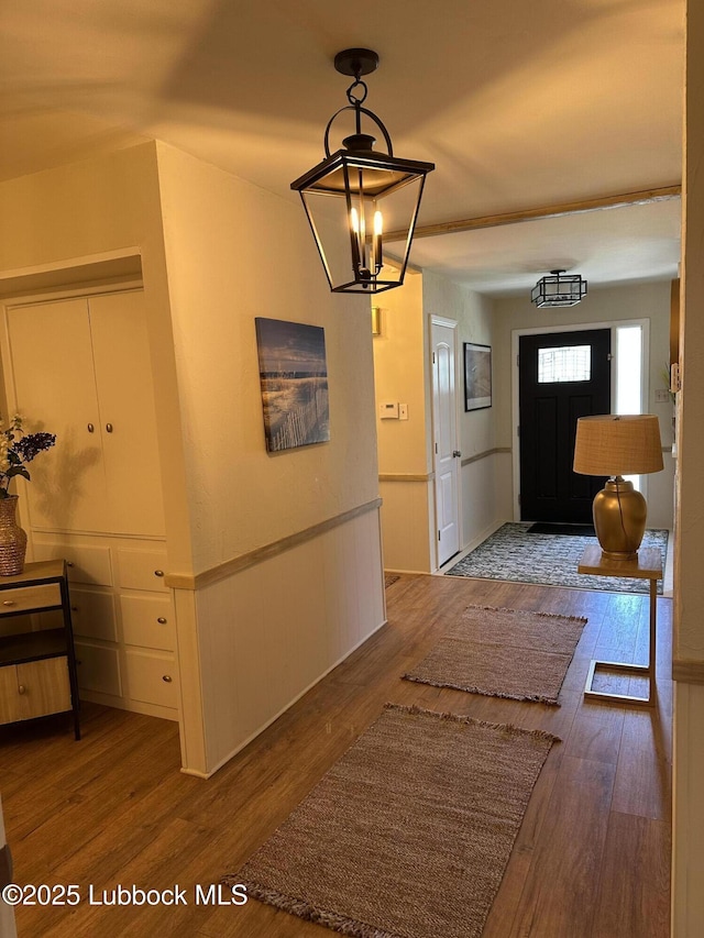 2326 58th St, Lubbock, TX 79412 - hall featuring wood finished floors and a chandelier