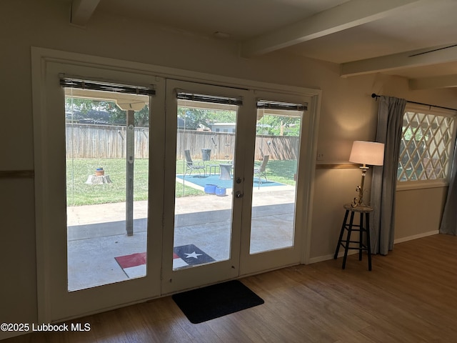 2326 58th St, Lubbock, TX 79412 - doorway to outside with beamed ceiling, wood finished floors, and french doors