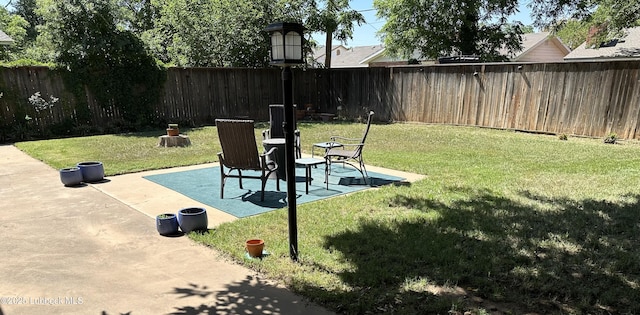 2326 58th St, Lubbock, TX 79412 - fenced backyard with a patio area