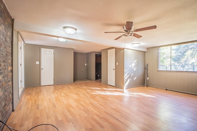 empty room with light hardwood / wood-style flooring and ceiling fan