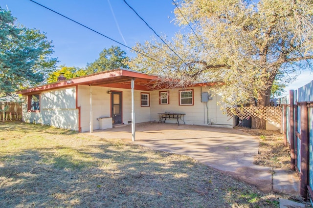 back of house featuring a yard and a patio