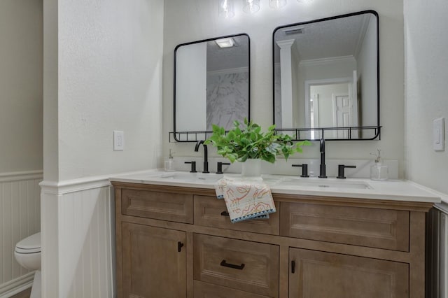 bathroom featuring vanity, crown molding, a textured ceiling, and toilet