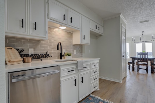 kitchen with dishwasher, sink, white cabinets, a textured ceiling, and light hardwood / wood-style flooring