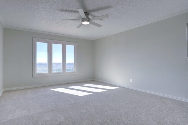 spare room with ornamental molding, light colored carpet, and a textured ceiling