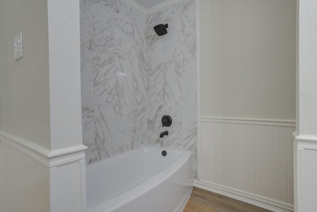 bathroom featuring tiled shower / bath and hardwood / wood-style floors