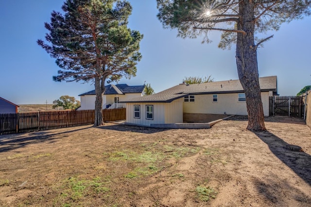 back of house with a lawn