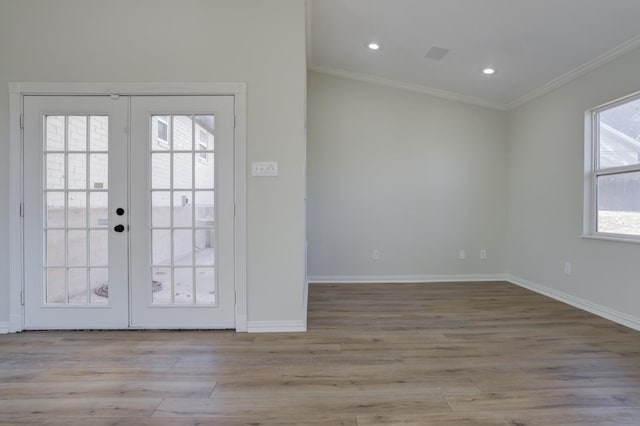 entryway with ornamental molding, light hardwood / wood-style floors, and french doors