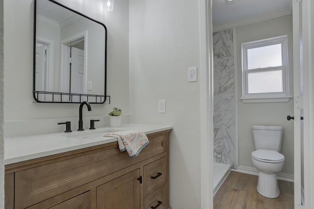 bathroom featuring walk in shower, toilet, wood-type flooring, ornamental molding, and vanity