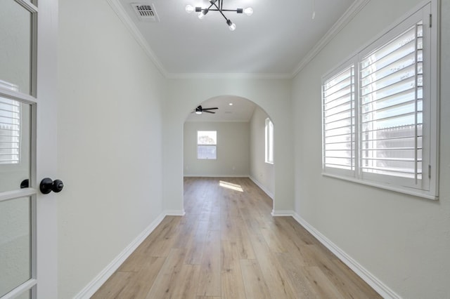 corridor featuring ornamental molding and light hardwood / wood-style floors